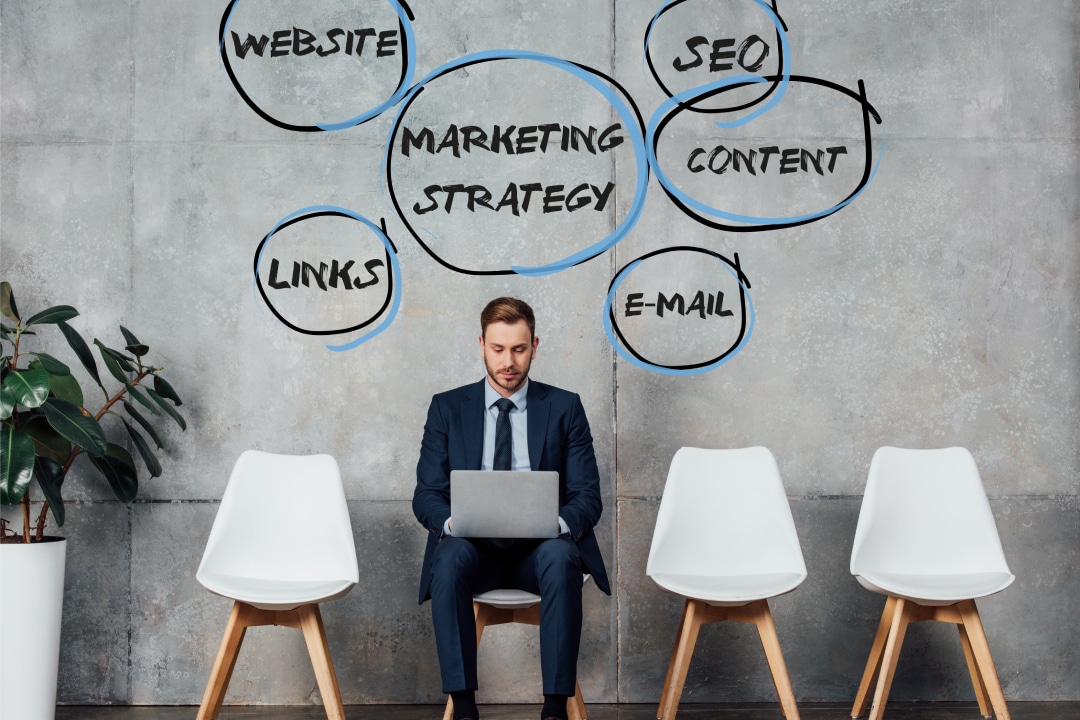 a guy using his laptop with the words website, links, marketing strategy, seo, content, and email on top of his head