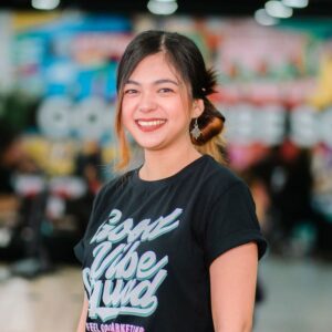 A portrait of our Creative Manager Regine wearing a black Good Vibe Squad shirt