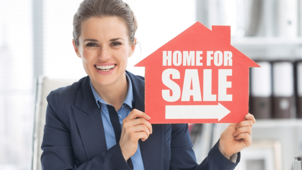 Realtor holding a "home for sale" sign to represent the question: "Can a real estate agent be a loan officer?"