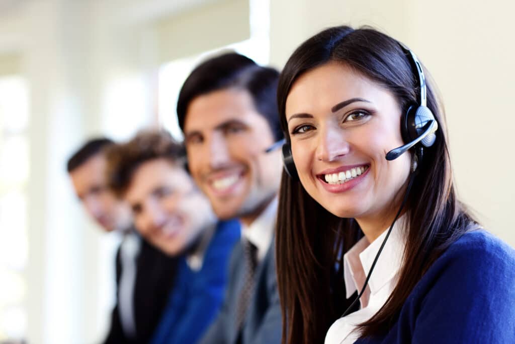 cheerful young businesspeople and colleagues in a call center office