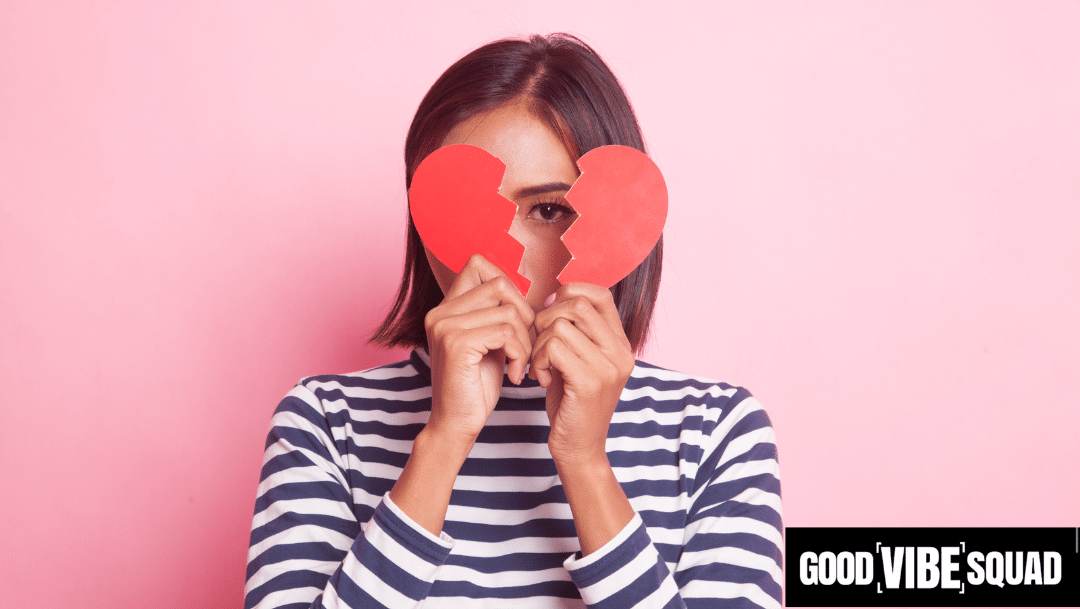 woman holding up a broken heart to symbolize breaking up with your mortgage marketing agency